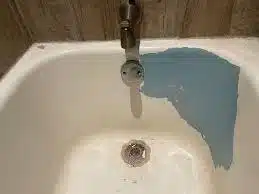 Chipped bathtub needing refinishing repair.