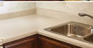 Beige kitchen countertop with stainless steel sink.